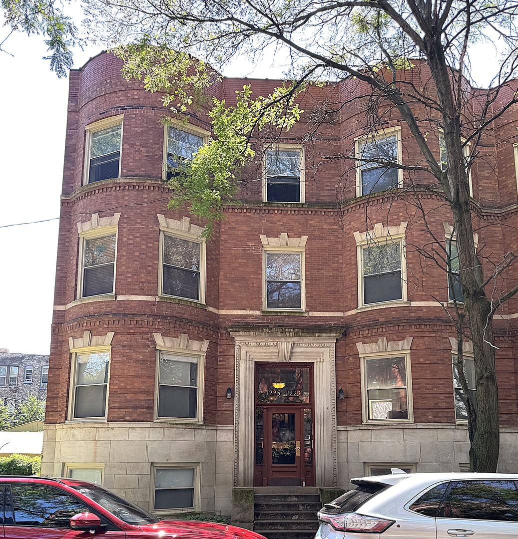 1223 East 52nd Street, Unit 1 Chicago, IL 60615 - Photo 1 of 1 a bricked building with a tree in front of it