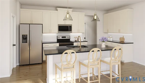 a kitchen with stainless steel appliances a refrigerator stove and microwave