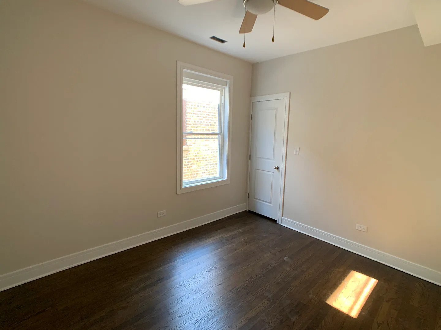 3306 West Cullom Avenue, Unit 1 Chicago, IL 60618 - Photo 9 of 16 an empty room with wooden floor and windows