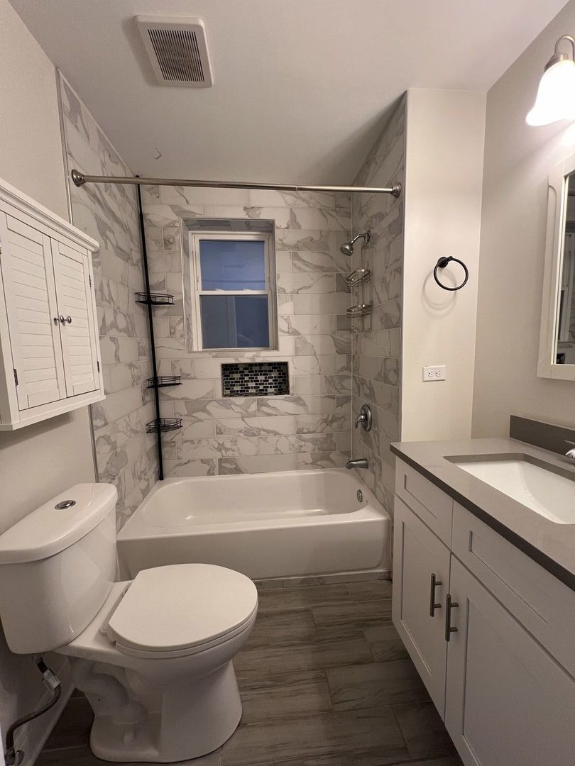 3306 West Cullom Avenue, Unit 1 Chicago, IL 60618 - Photo 10 of 16 a bathroom with a toilet a sink and bathtub