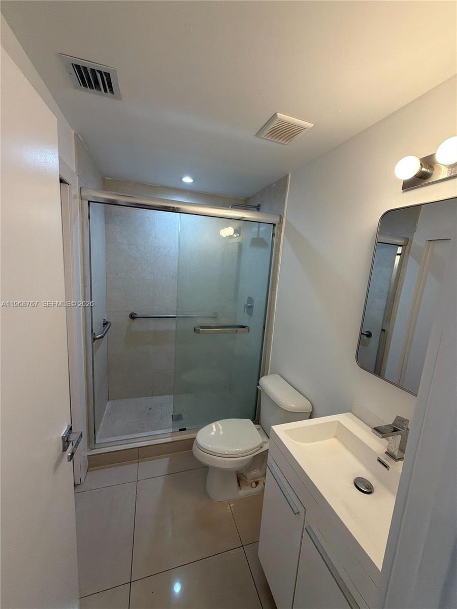 829 Southwest 18th Avenue, Unit 109 Miami, FL 33135 - Photo 4 of 10 a bathroom with a toilet sink and shower