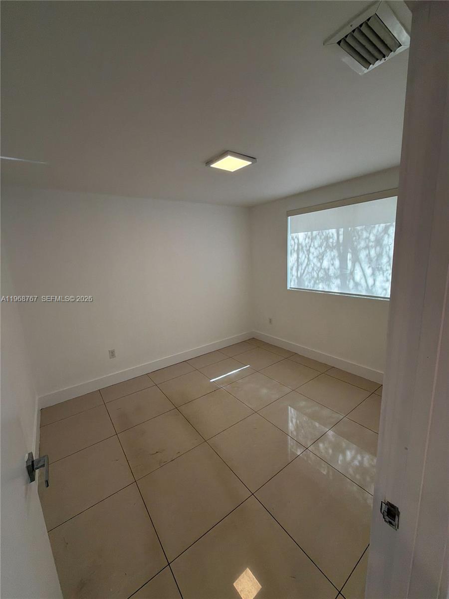 829 Southwest 18th Avenue, Unit 109 Miami, FL 33135 - Photo 6 of 10 a view of an empty room with a window