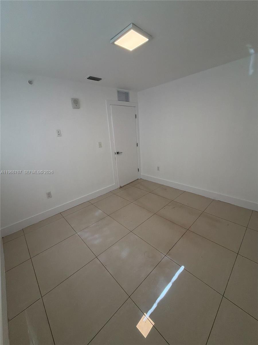 829 Southwest 18th Avenue, Unit 109 Miami, FL 33135 - Photo 7 of 10 a view of an empty room with a window
