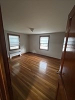 36 St Marks Road, Unit 3 Boston, MA 02124 - Photo 5 of 7 a view of an empty room with wooden floor and a window