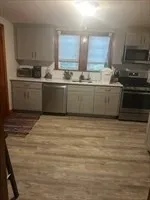 a kitchen with stainless steel appliances granite countertop a sink stove and cabinets