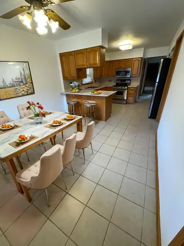 a bedroom with a bed and a flat tv screen on dresser
