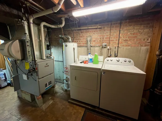 a bathroom with a sink a toilet a mirror and shower
