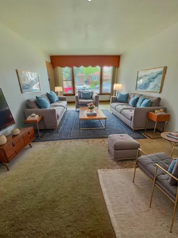 a living room with furniture and a large window