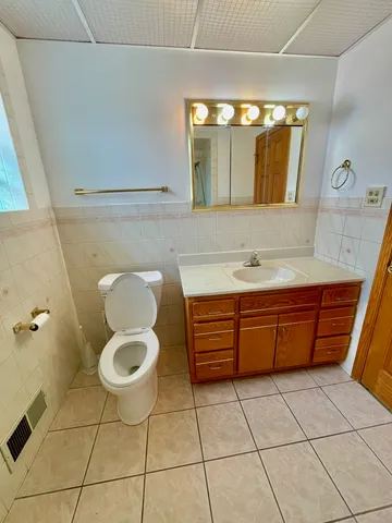 a bedroom with a bed and a large mirror with a flat tv screen