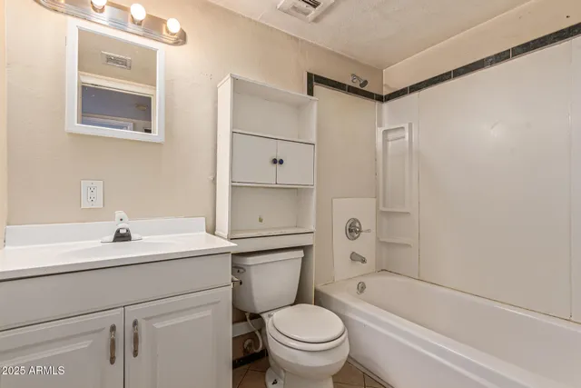 a bathroom with a sink toilet vanity and tub