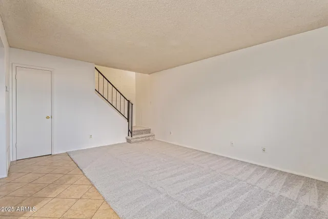 a view of an empty room with stairs