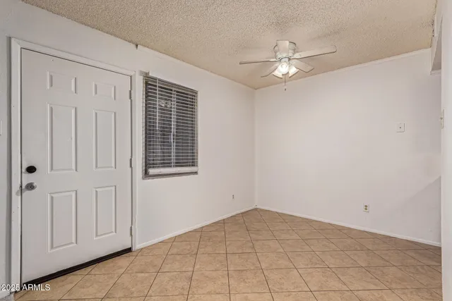 a view of a livingroom with a ceiling fan and window