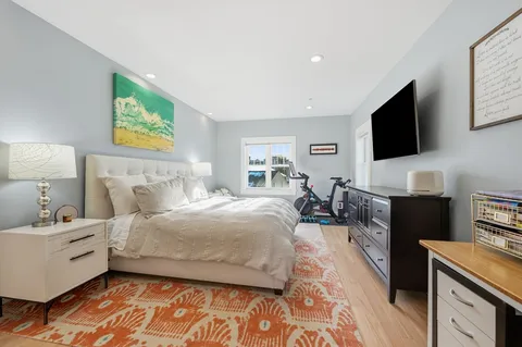 a bedroom with a bed and a couch