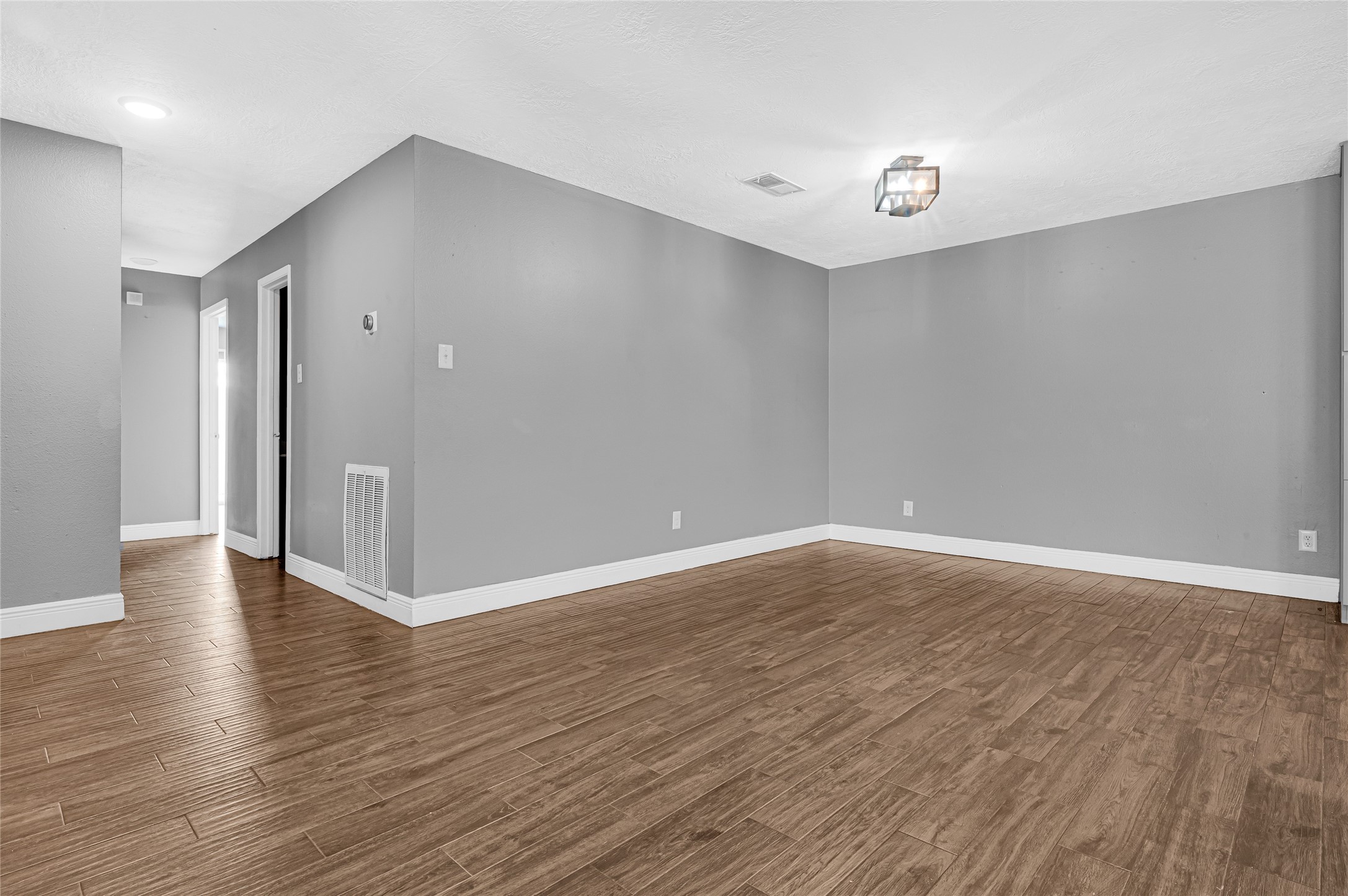 4170 Amir Street Houston, TX 77072 - Photo 8 of 18 a view of an empty room with wooden floor