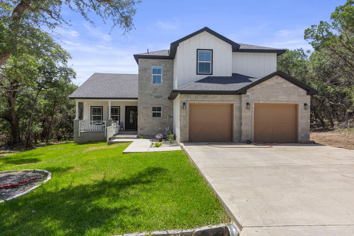 a front view of a house with a yard garage and outdoor seating