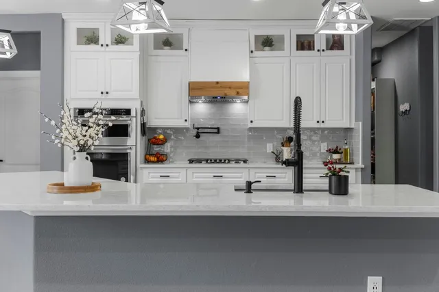 a view of kitchen with living room and stainless steel appliances