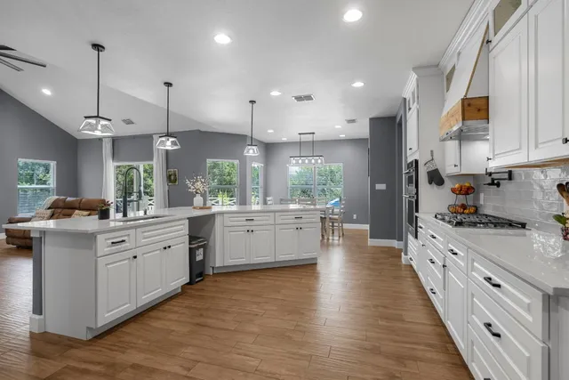a view of swimming pool with lounge chair and dinning table under an umbrella
