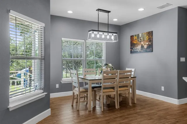 a large kitchen with stainless steel appliances kitchen island granite countertop a large island in the center