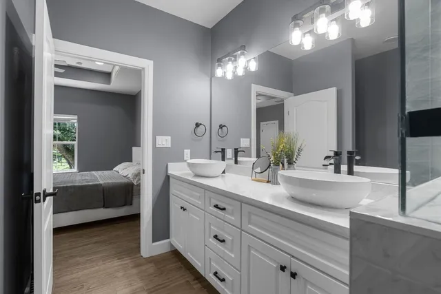 a bedroom with a bed and a chandelier