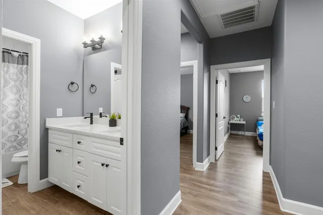 a view of a hallway with wooden floor and closet