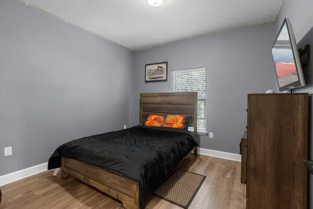 a bathroom with a granite countertop sink a toilet and a mirror