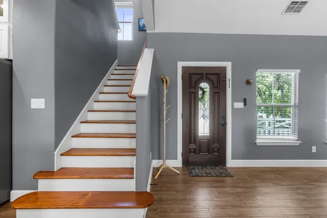 a view of an entryway with wooden floor and door