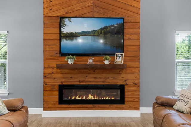 a kitchen with counter top space sink stove and wooden floor