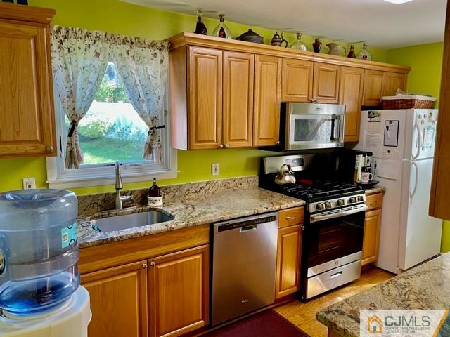 5 Bowser Road New Brunswick, NJ 08901 - Photo 22 of 45 a kitchen with granite countertop a stove a sink and a microwave