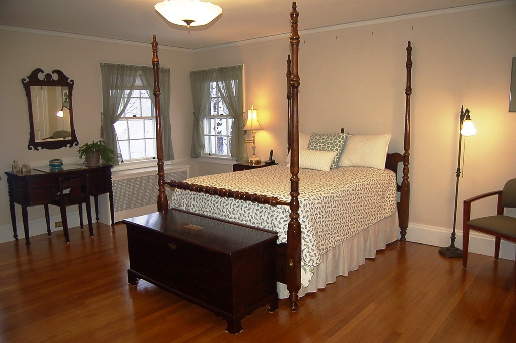 346 Gaskill Street Woonsocket, RI 02895 - Photo 15 of 25 a bedroom with a bed a table and wooden floor