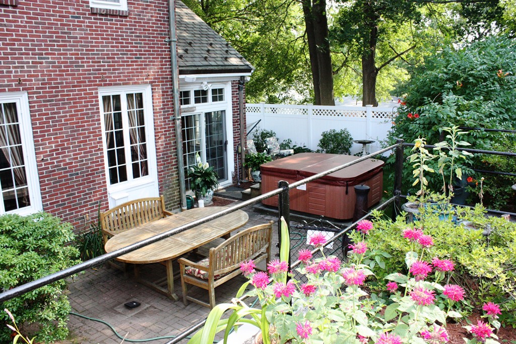 346 Gaskill Street Woonsocket, RI 02895 - Photo 25 of 25 a backyard of a house with table and chairs and wooden fence