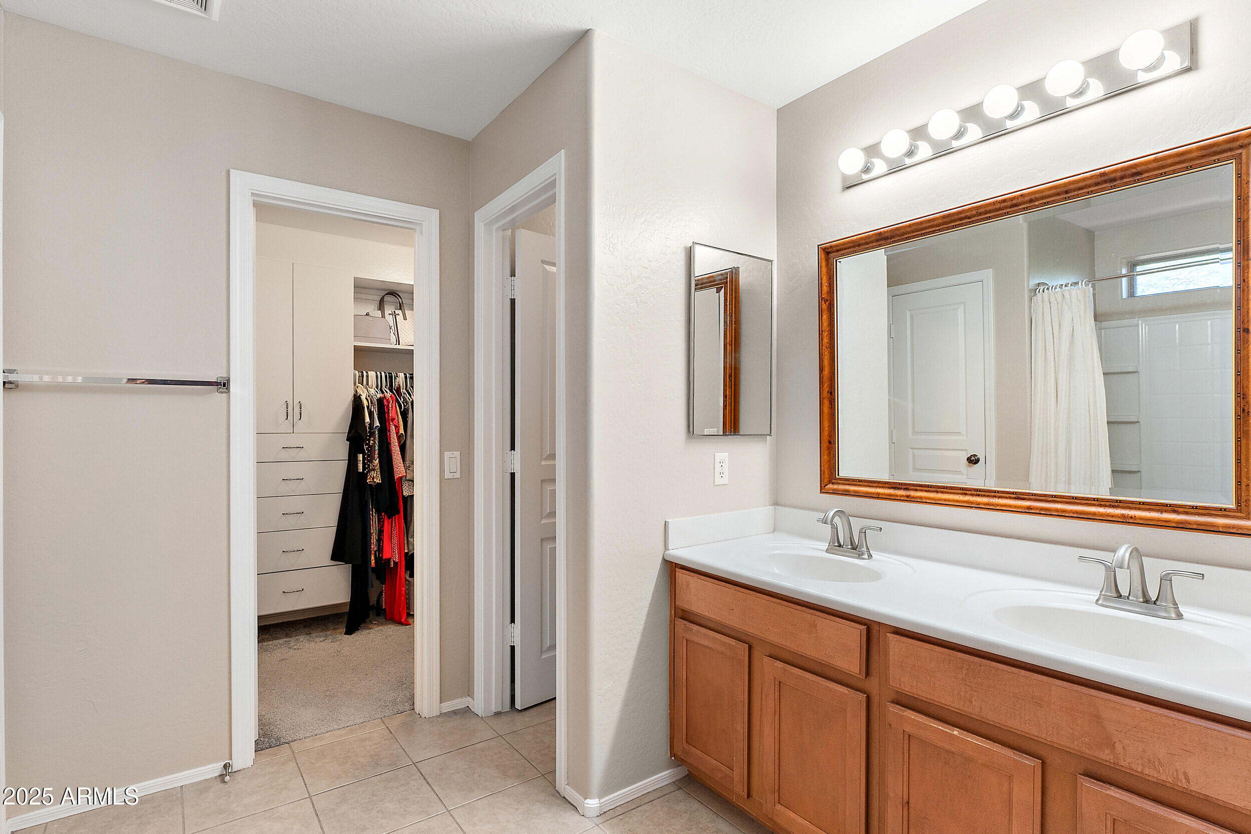 3643 West Medinah Court Anthem, AZ 85086 - Photo 11 of 58 a bathroom with a double vanity sink and a mirror