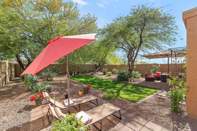 a view of a backyard with sitting area