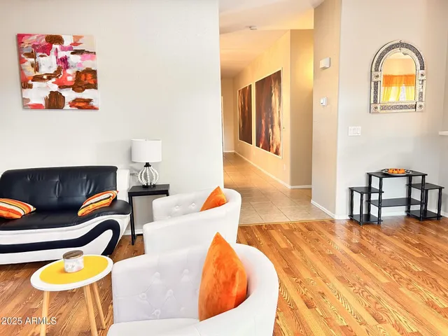 a living room with furniture rug and wooden floor