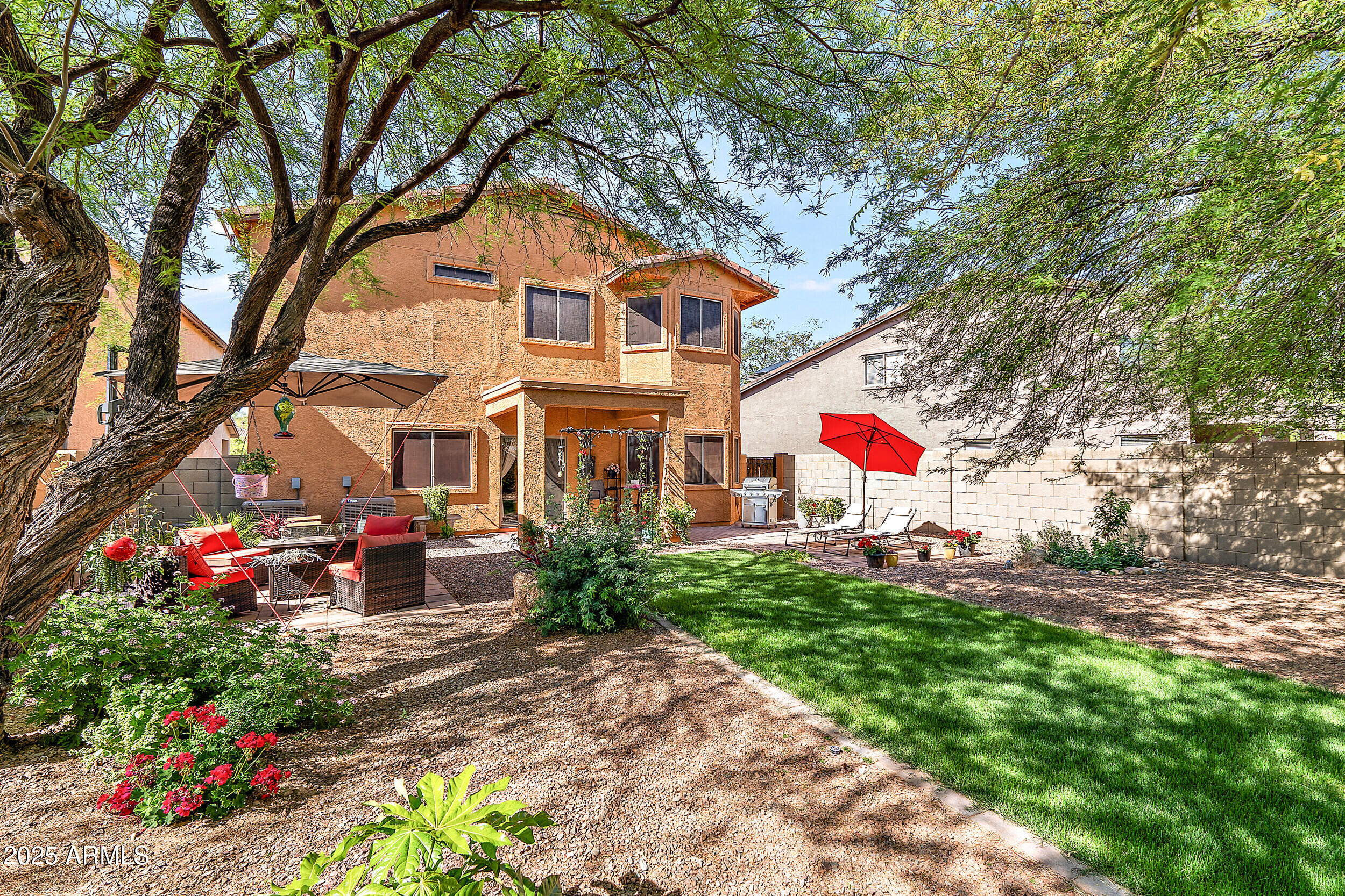 3643 West Medinah Court Anthem, AZ 85086 - Photo 44 of 58 a front view of a house with a yard and fountain