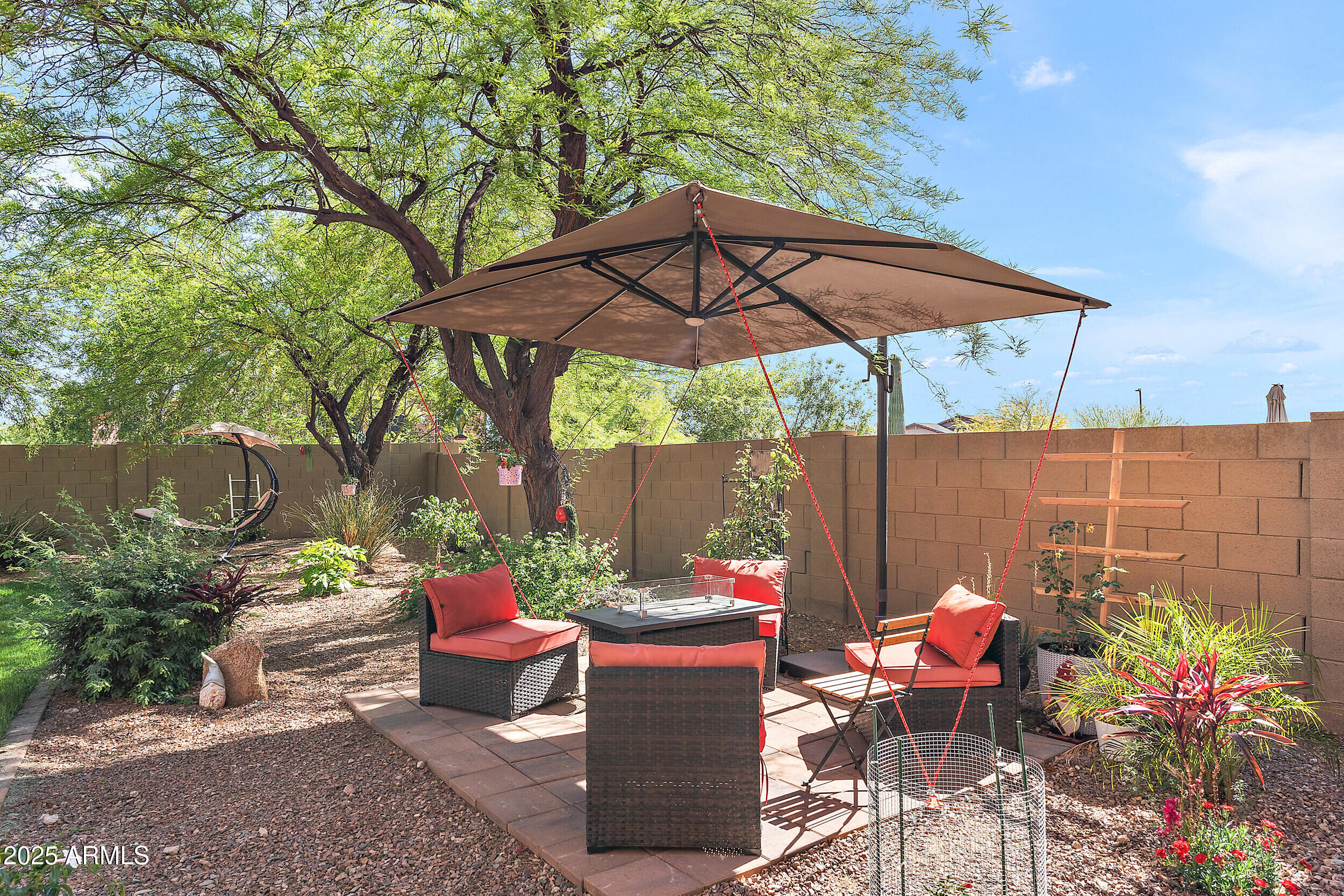 3643 West Medinah Court Anthem, AZ 85086 - Photo 46 of 58 a patio with tables and chairs under an umbrella
