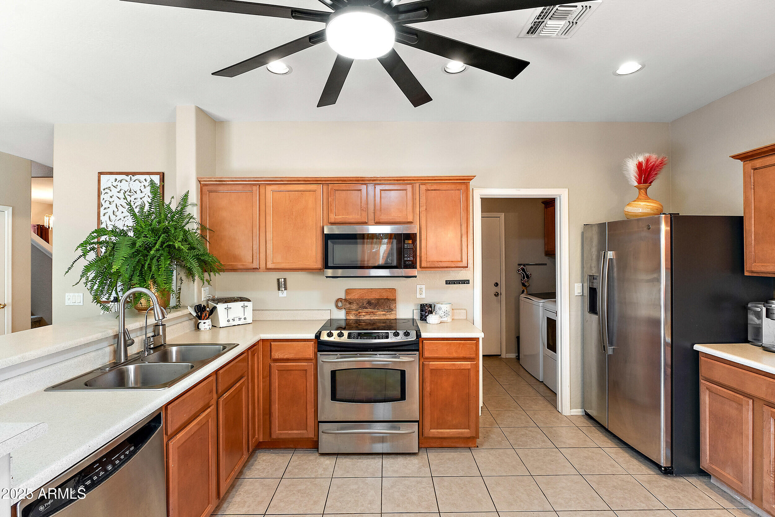 3643 West Medinah Court Anthem, AZ 85086 - Photo 5 of 58 a kitchen with a refrigerator and a sink
