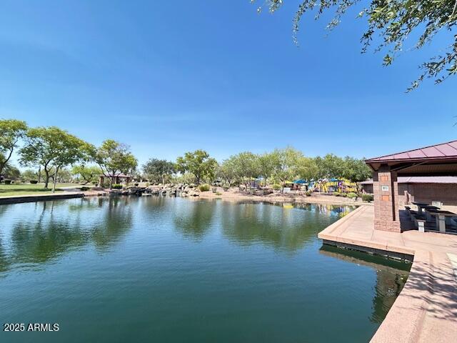 3643 West Medinah Court Anthem, AZ 85086 - Photo 58 of 58 a view of a lake with a house in the background