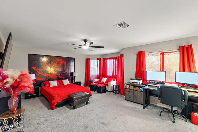 a living room with furniture a large window and a chandelier