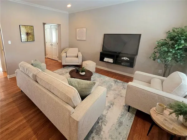 a living room with furniture and a flat screen tv