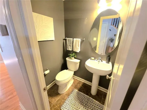 a bathroom with a sink toilet and a mirror