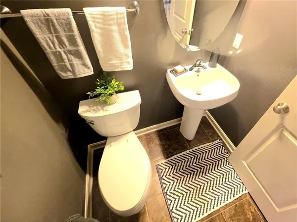 a bathroom with a sink toilet and mirror