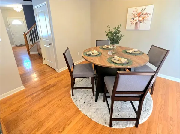 a view of a dining room with furniture and wooden floor