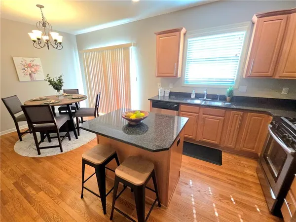 a kitchen with a dining table chairs and a refrigerator