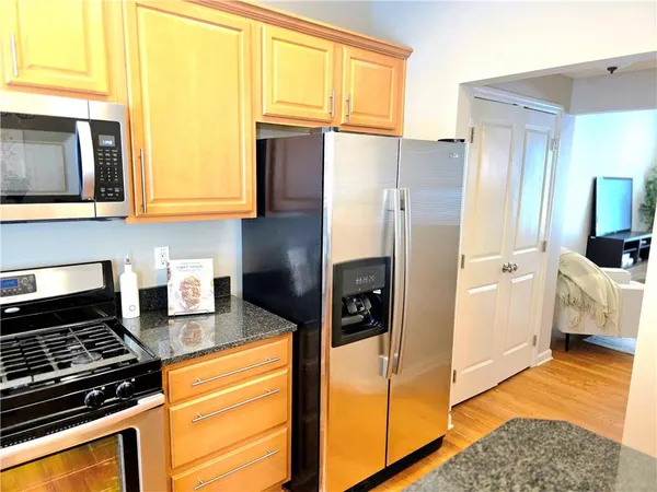 a kitchen with granite countertop a refrigerator and a stove