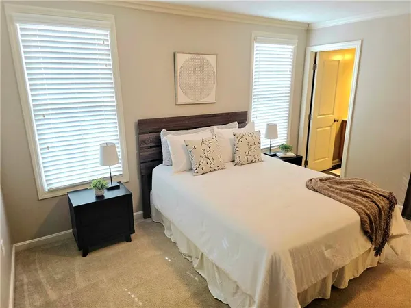 a bedroom with bed and window
