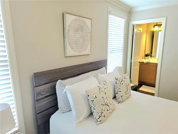 a bed sitting in a bedroom next to a window