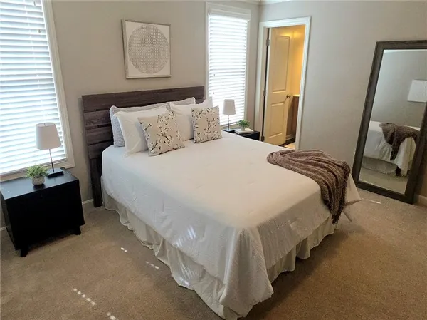 a bedroom with bed and window
