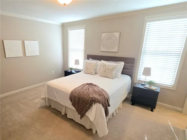 a spacious bedroom with a bed and window