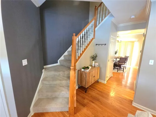 a view of entryway and hall with wooden floor