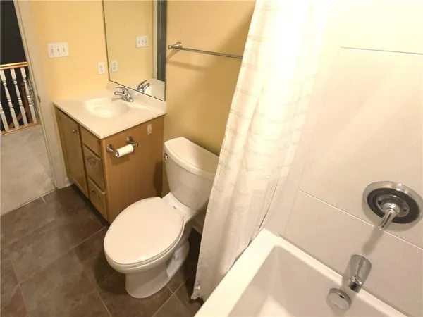 a white toilet sitting next to a bathroom sink